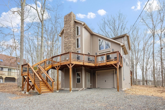 view of front of property featuring a chimney, a wooden deck, a garage, stairway, and gravel driveway