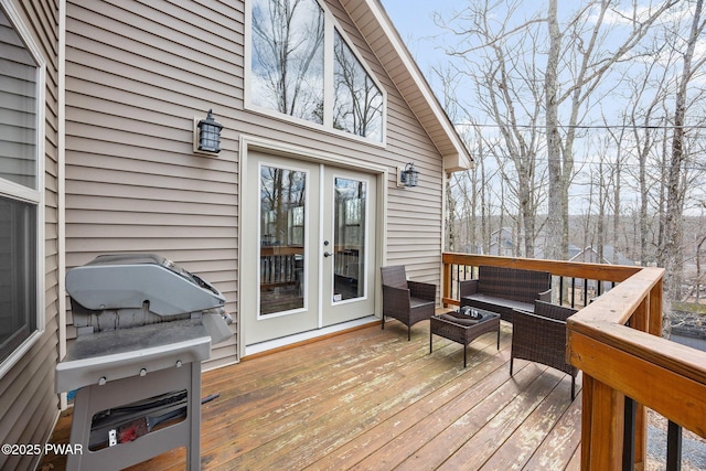 wooden deck with an outdoor hangout area and french doors