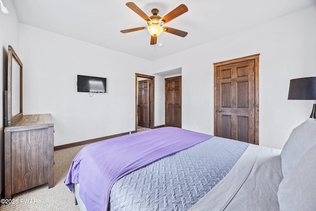 bedroom with ceiling fan, baseboards, and carpet