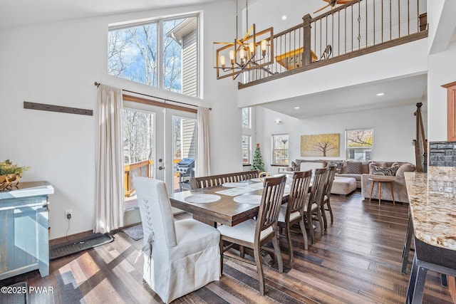 dining area featuring a healthy amount of sunlight, french doors, and dark wood-style floors