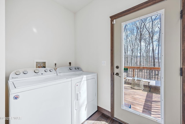 clothes washing area with laundry area, baseboards, independent washer and dryer, and wood finished floors