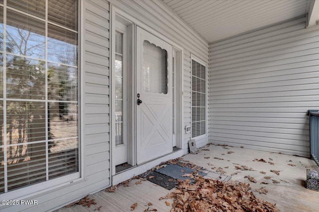 view of exterior entry with a porch