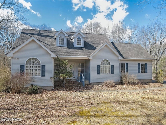 view of front facade with roof with shingles and covered porch