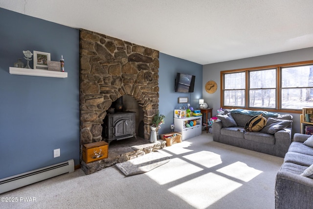 carpeted living room featuring a baseboard heating unit, a wood stove, and a textured ceiling