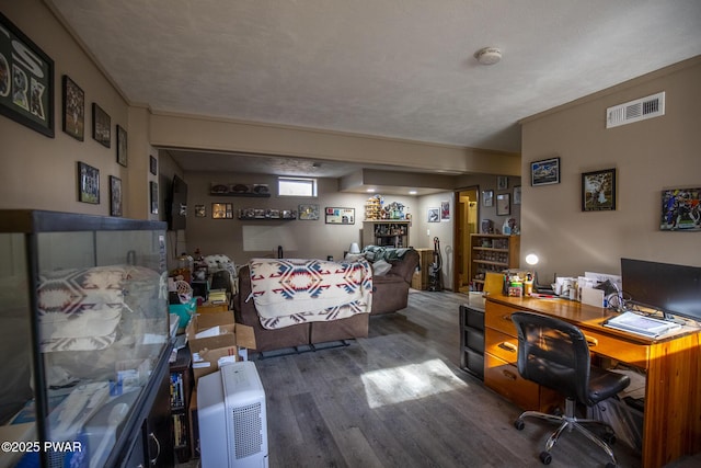 home office featuring visible vents and wood finished floors