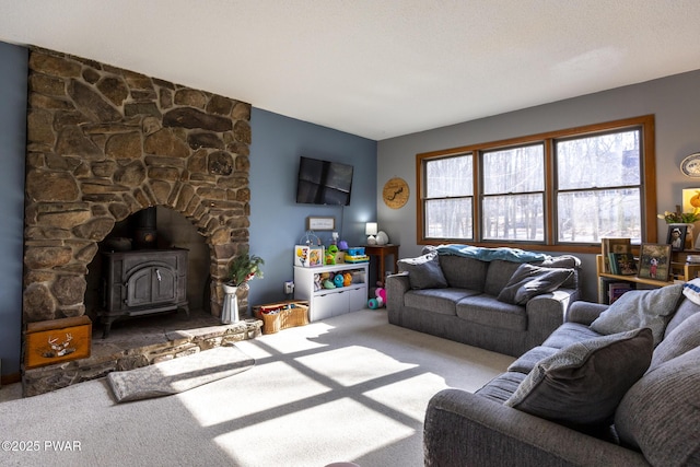 living room featuring carpet flooring and a wood stove