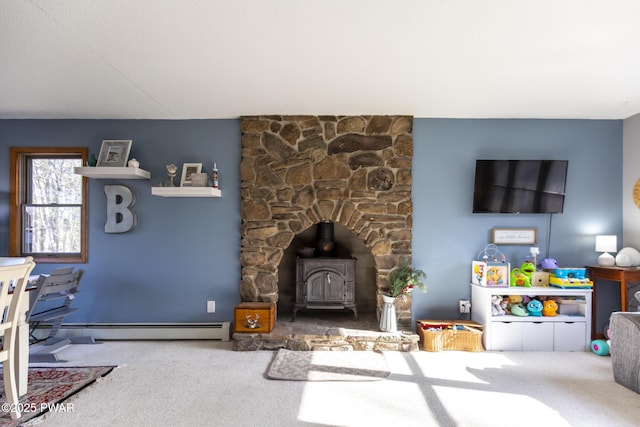 living room with carpet floors, a wood stove, and a baseboard radiator