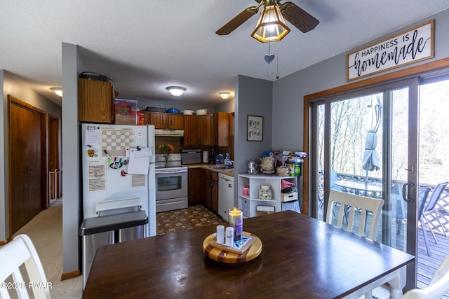 dining area featuring a textured ceiling and ceiling fan