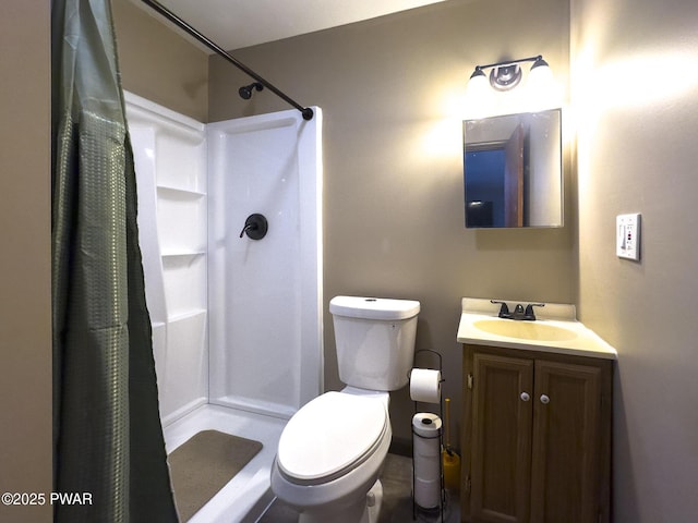 full bath featuring vanity, a shower stall, and toilet
