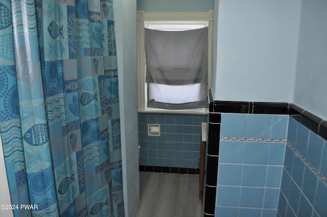 bathroom with tile walls