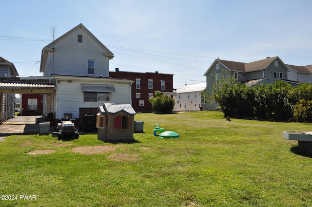 rear view of house featuring a yard