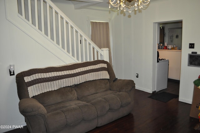 living room featuring dark wood-type flooring and an inviting chandelier