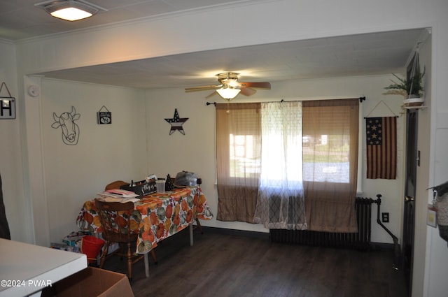 dining room featuring crown molding, ceiling fan, and dark wood-type flooring