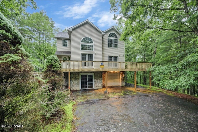 102 Eagle Rock Rd, Lackawaxen, PA 18435 - back of house with driveway, stone siding, a deck, a carport, and a garage