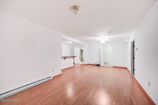 102 Eagle Rock Rd, Lackawaxen, PA 18435 - unfurnished living room featuring baseboard heating, a ceiling fan, and light wood finished floors