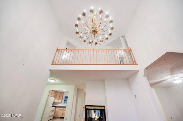 102 Eagle Rock Rd, Lackawaxen, PA 18435 - unfurnished living room with a high ceiling, a chandelier, and a multi sided fireplace
