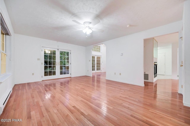 102 Eagle Rock Rd, Lackawaxen, PA 18435 - empty room with a ceiling fan, light wood-style flooring, a baseboard radiator, french doors, and a textured ceiling