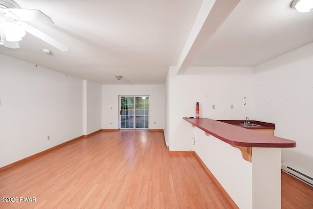 102 Eagle Rock Rd, Lackawaxen, PA 18435 - empty room with light wood finished floors, a baseboard radiator, a ceiling fan, and a smoke detector