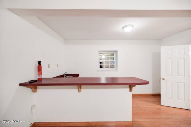 102 Eagle Rock Rd, Lackawaxen, PA 18435 - kitchen with a breakfast bar area, light wood-type flooring, and dark countertops