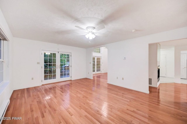 102 Eagle Rock Rd, Lackawaxen, PA 18435 - empty room featuring french doors, a ceiling fan, light wood-style flooring, a textured ceiling, and a baseboard radiator
