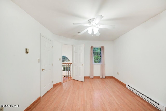 102 Eagle Rock Rd, Lackawaxen, PA 18435 - unfurnished bedroom featuring a baseboard radiator, light wood finished floors, and a ceiling fan