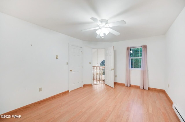 102 Eagle Rock Rd, Lackawaxen, PA 18435 - spare room featuring baseboard heating, light wood-type flooring, and a ceiling fan