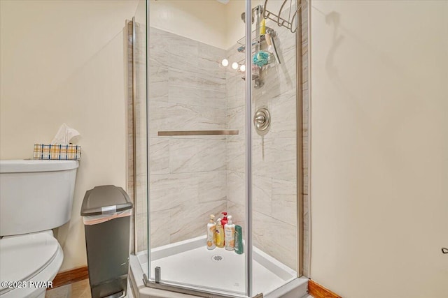 bathroom featuring toilet and an enclosed shower