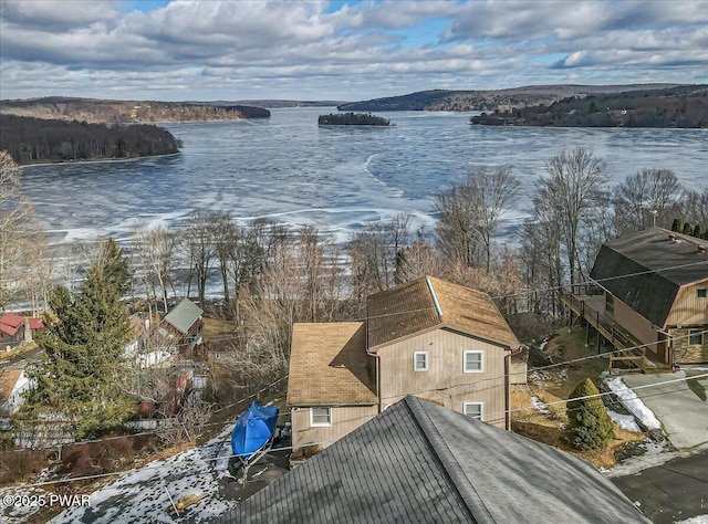 snowy aerial view featuring a water view