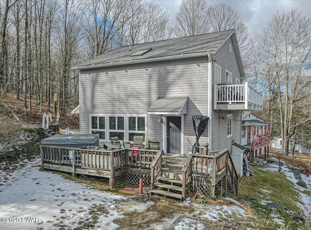 snow covered house with a wooden deck