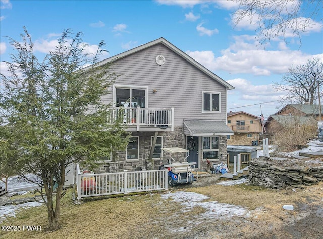 rear view of property featuring a balcony