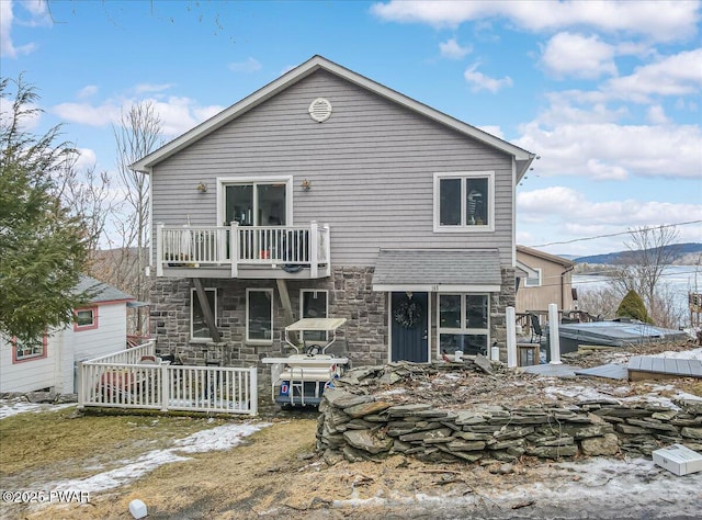 rear view of property with a balcony