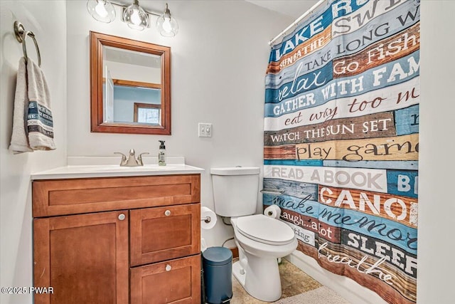 bathroom featuring vanity, toilet, and curtained shower