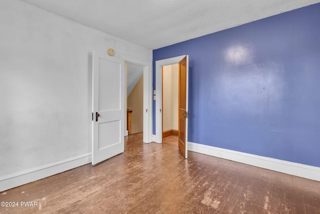 spare room with a textured ceiling