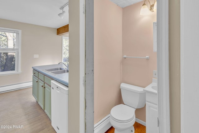 bathroom with hardwood / wood-style floors, vanity, track lighting, toilet, and a baseboard radiator