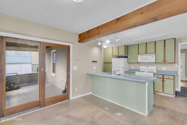 kitchen with kitchen peninsula, white appliances, light hardwood / wood-style floors, and green cabinets