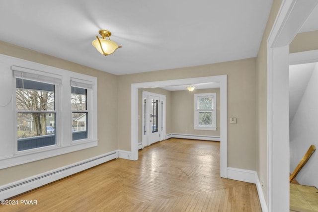 interior space with light parquet floors and a baseboard radiator