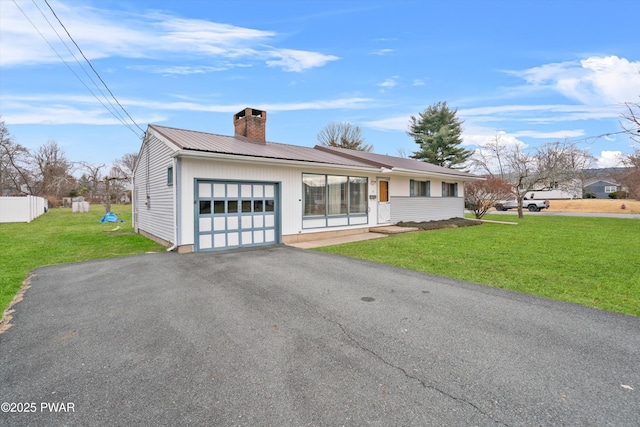 view of front facade with a garage and a front lawn