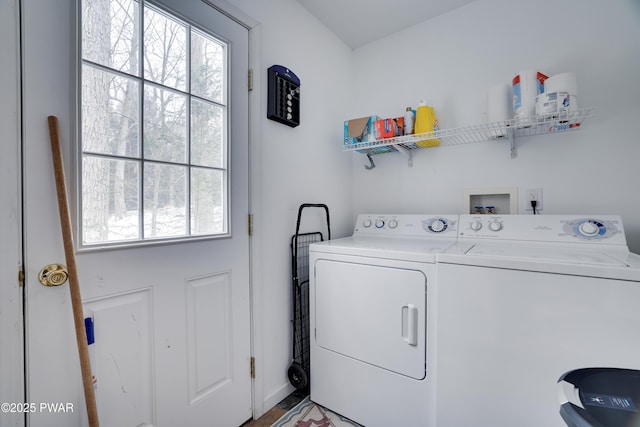 laundry area featuring laundry area, a healthy amount of sunlight, and washing machine and clothes dryer