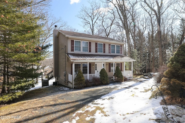 132 Spruce Rd, Tafton, PA 18464 - traditional-style house with a chimney, covered porch, and cooling unit