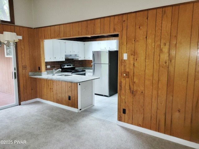 803 Lariat Ct, Hawley, PA 18428 - kitchen with freestanding refrigerator, electric stove, under cabinet range hood, a sink, and light colored carpet