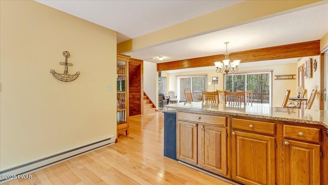 kitchen with a baseboard heating unit, a chandelier, light wood-style floors, beamed ceiling, and hanging light fixtures
