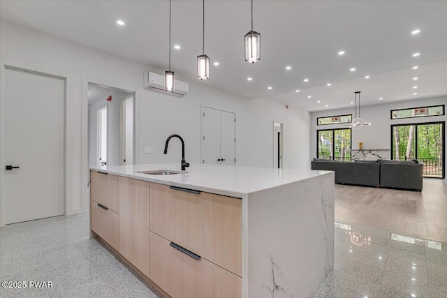 517 Maple Ridge Dr, Lords Valley, PA 18428 - kitchen with modern cabinets, light brown cabinetry, a sink, an AC wall unit, and light stone countertops