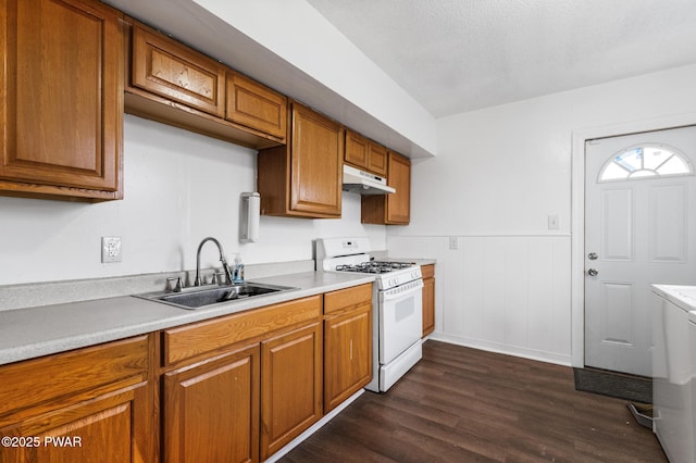 kitchen with dark wood-type flooring, sink, and white range with gas stovetop