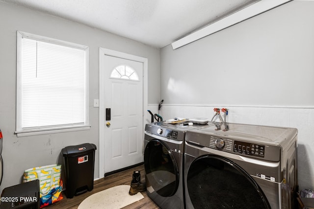 washroom featuring dark hardwood / wood-style flooring, washer and clothes dryer, and a textured ceiling