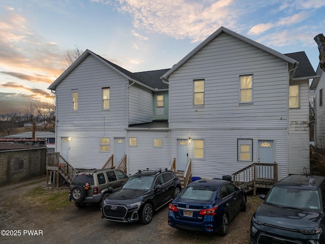 view of back house at dusk