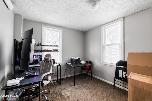 carpeted office featuring a textured ceiling and plenty of natural light