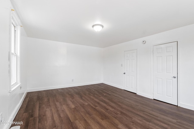 spare room featuring dark wood-type flooring