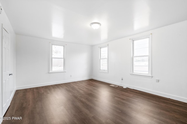 spare room featuring dark hardwood / wood-style flooring