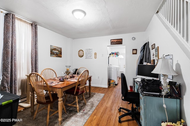 interior space featuring a textured ceiling, hardwood / wood-style flooring, and a baseboard radiator