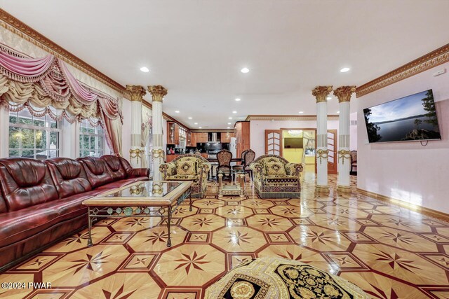 tiled living room with decorative columns and ornamental molding